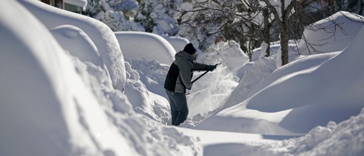 A resident shovels snow away from the entrance to his home in Union City, New Jersey, across the Hudson River from Midtown Manhattan, after the second-biggest winter storm in New York history, January 24, 2016. REUTERS/Rickey Rogers