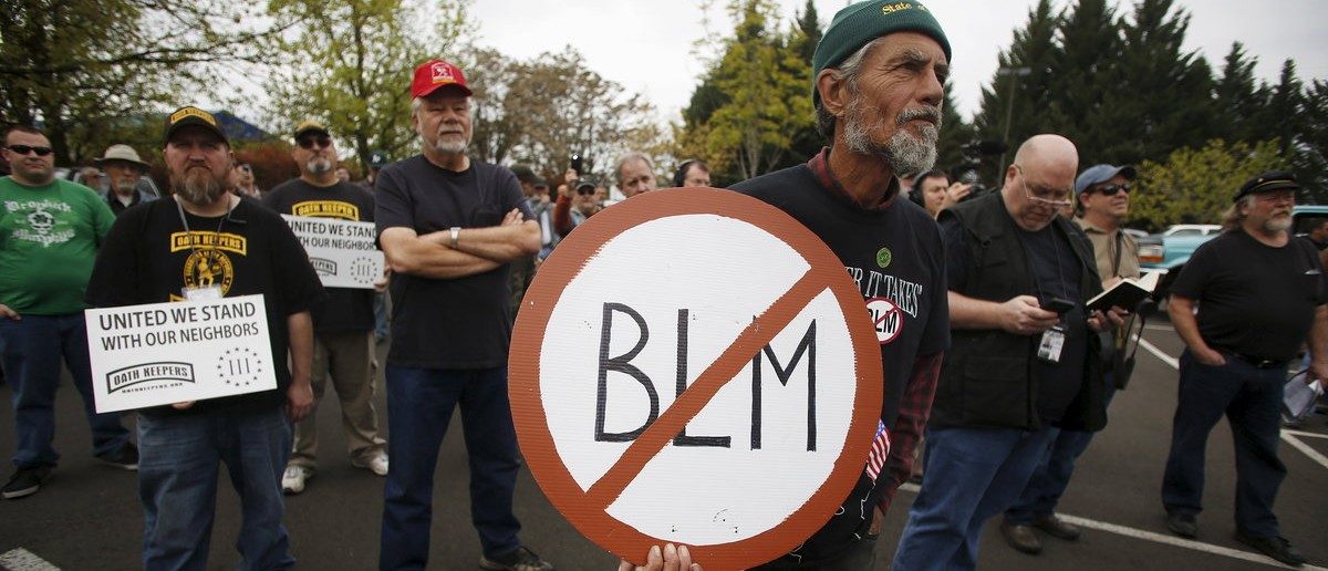 A Sugar Pine Miner supporter holds a anti-BLM sign at a rally outside the Bureau of Land Management's offices in Medford, Oregon April 23, 2015. The owners of the Oregon gold mine who called in armed activists the Oath Keepers to protect their claim amid a bitter land use dispute with the U.S. government have appealed a federal stop-work order, U.S. officials said on Thursday. REUTERS/Jim Urquhart 