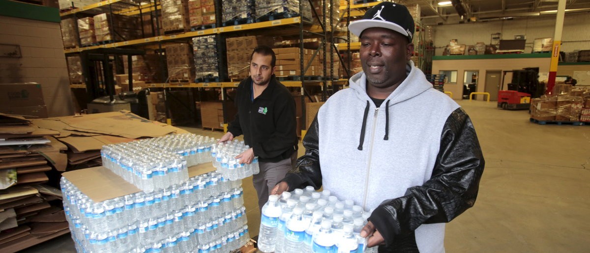 Anthony Fordham picks up water at the Food Bank of Eastern Michigan to deliver to a school after elevated levels of lead were found in the city's water in Flint, Michigan December 16 2015 REUTTERS/Rebecca Cook