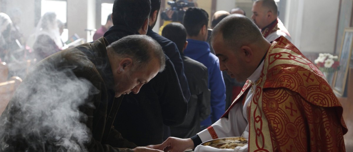 Assyrians attend a mass in solidarity with the Assyrians abducted by Islamic State fighters in Syria earlier this week, inside Ibrahim al-Khalil church in Jaramana, eastern Damascus March 1, 2015. Militants in northeast Syria are now estimated to have abducted at least 220 Assyrian Christians this week, a group monitoring the war reported. REUTERS/Omar Sanadiki