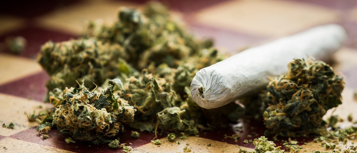 Closeup of marijuana joint and buds on a checkerboard table with (Shutterstock/Wollertz)