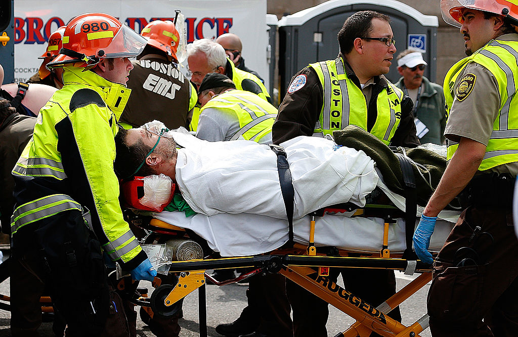 A man is loaded into an ambulance after he was injured by one of two bombs exploded during the 117th Boston Marathon near Copley Square on April 15, 2013 in Boston, Massachusetts. Two people are confirmed dead and at least 23 injured after two explosions went off near the finish line to the marathon. (Getty Images)