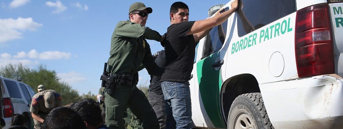 A U.S. Border Patrol officer body searches an undocumented immigrant after he illegally crossed the U.S.-Mexico border and was caught on December 7, 2015 near Rio Grande City, Texas. Border Patrol agents continue to detain hundreds of thousands of undocumented immigrants trying to avoid capture after crossing into the United States, even as migrant families and unaccompanied minors from Central America cross and turn themselves in to seek asylum. John Moore/Getty Images.