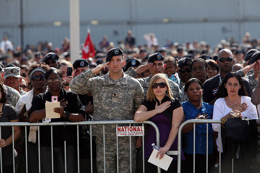 People attend the memorial service that U.S. President Barack Obama and first lady Michelle Obama are attending for the thirteen victims of the shooting rampage by U.S. Army Major Nidal Malik Hasan on November 10, 2009 in Fort Hood, Texas. (Getty Images)