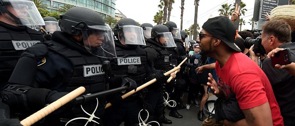 Police move in to remove anti-Trump protesters during a protest rally outside Republican presidential candidate Donald Trump