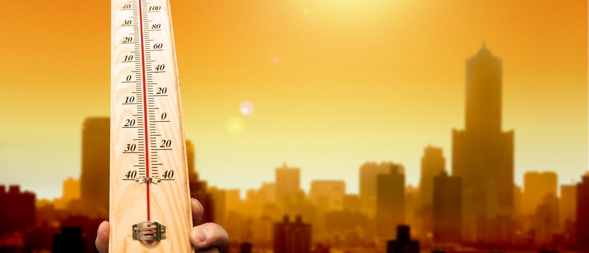 Heat wave in the city and hand showing thermometer for high temperature.

(Shutterstock/Tom Wang)