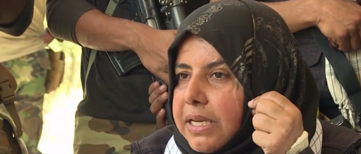 Um Hanadi shows scars from battling ISIS. (screenshot from CNN video)