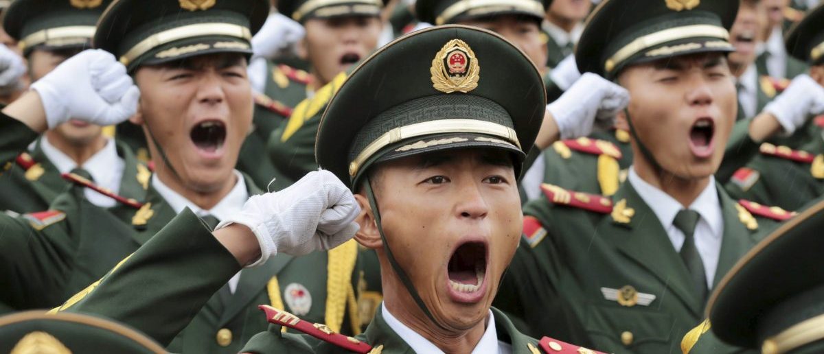 Paramilitary policemen and members of a gun salute team shout slogans at an oath-taking ceremony for the upcoming military parade to mark the 70th anniversary of the end of the World War Two, at a military base in Beijing, China, September 1, 2015. REUTERS/Stringer