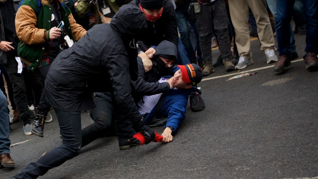 A protester chokes a Trump supporter as they attempt to steal his - Daily Caller - Grae Stafford