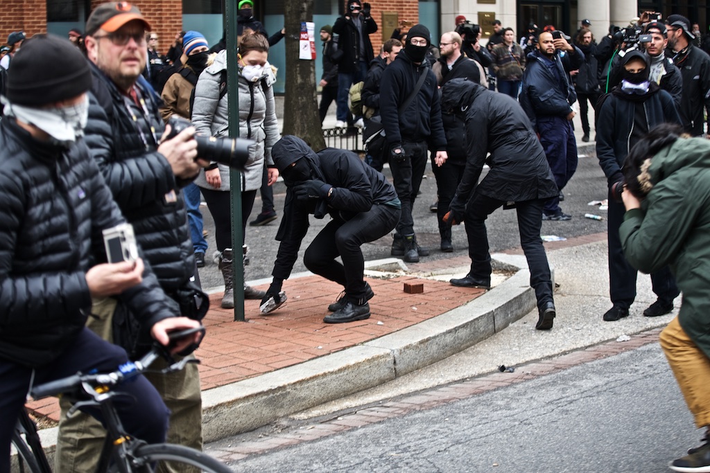 Bricks being pulled from the sidewalk on K steet during the protest - Daily Caller - Grae Stafford