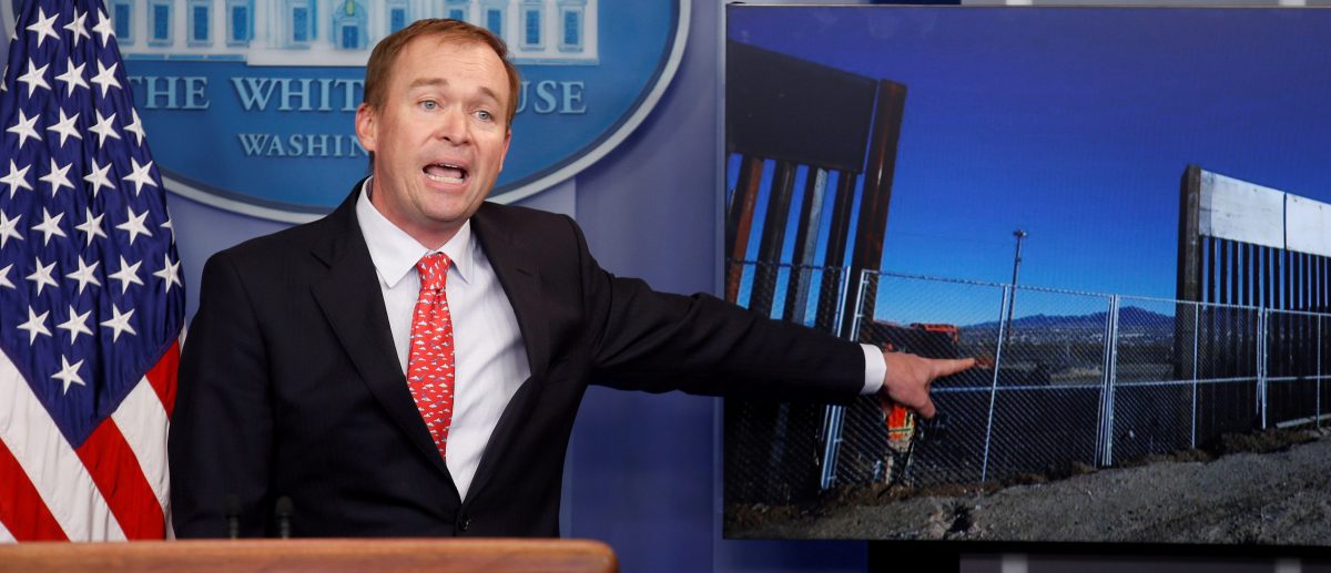 Director of the Office of Management and Budget Mick Mulvaney points to a picture of construction of the southern border while speaking about the budget agreement reached by Congress during a press briefing at the White House in Washington, U.S., May 2, 2017. (PHOTO: REUTERS/Joshua Roberts)