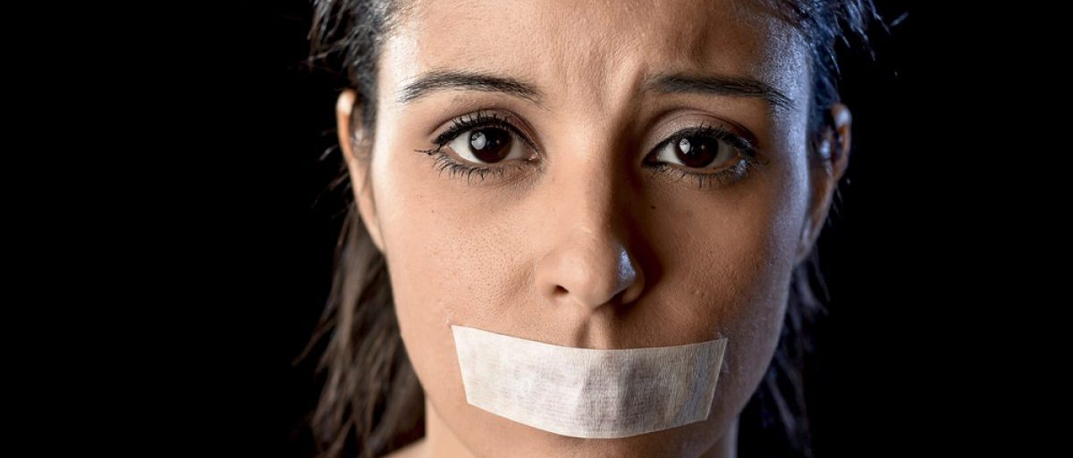 Woman with mouth taped shut (Shutterstock/Marcos Mesa Sam Wordley)