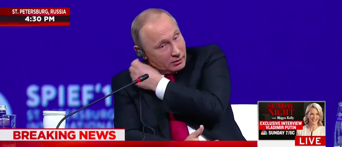 Screen Shot Vladimir Putin Pulls Out Ear Piece At St. Petersburg Economic Forum (June 2, 2017)
