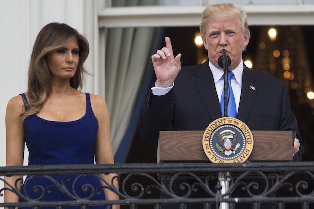 WASHINGTON, DC - JULY 4: U.S. President Donald Trump delivers remarks as first lady Melania Trump looks on from the Truman Balcony on July 4, 2017, in Washington, DC. The president was hosting a picnic for military families for the July 4 holiday. (Photo by Zach Gibson/Getty Images)