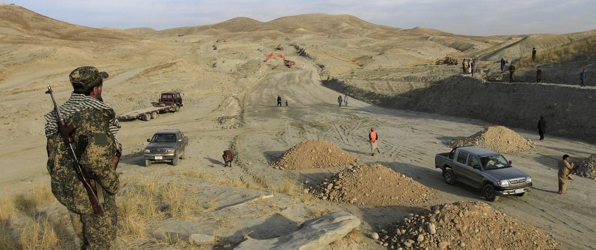 An Afghan security personnel keeps watch at a road construction site, which is being built by a Chinese company, in Khogyani district of Nangarhar province November 19, 2015. A new road linking the Afghan capital with a trade hub near Pakistan has been stuck in the slow lane since a state-owned Chinese company took the contract to build it two years ago, bedevilled by militant attacks and accusations of mismanagement. Picture taken November 19, 2015. REUTERS/Parwiz.