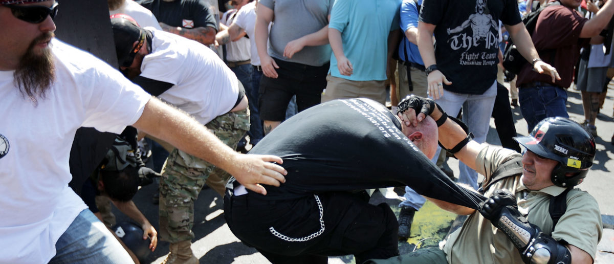 CHARLOTTESVILLE, VA - AUGUST 12:  White nationalists, neo-Nazis and members of the "alt-right" clash with antifa as they enter Lee Park during the "Unite the Right" rally August 12, 2017 in Charlottesville, Virginia. After clashes with anti-fascist protesters and police the rally was declared an unlawful gathering and people were forced out of Lee Park, where a statue of Confederate General Robert E. Lee is slated to be removed.  (Photo by Chip Somodevilla/Getty Images)
