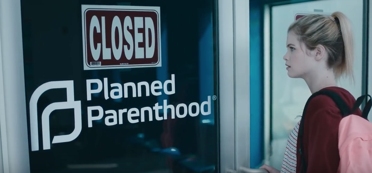 Girl faces closed abortion clinic. (Youtube screenshot/Joss Whedon)