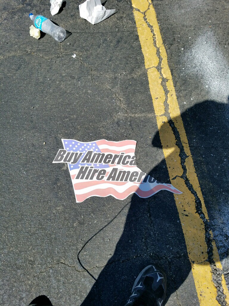 Anti-Trump activists rip up American flags with pro-American message. Photo courtesy of Rob Cortis