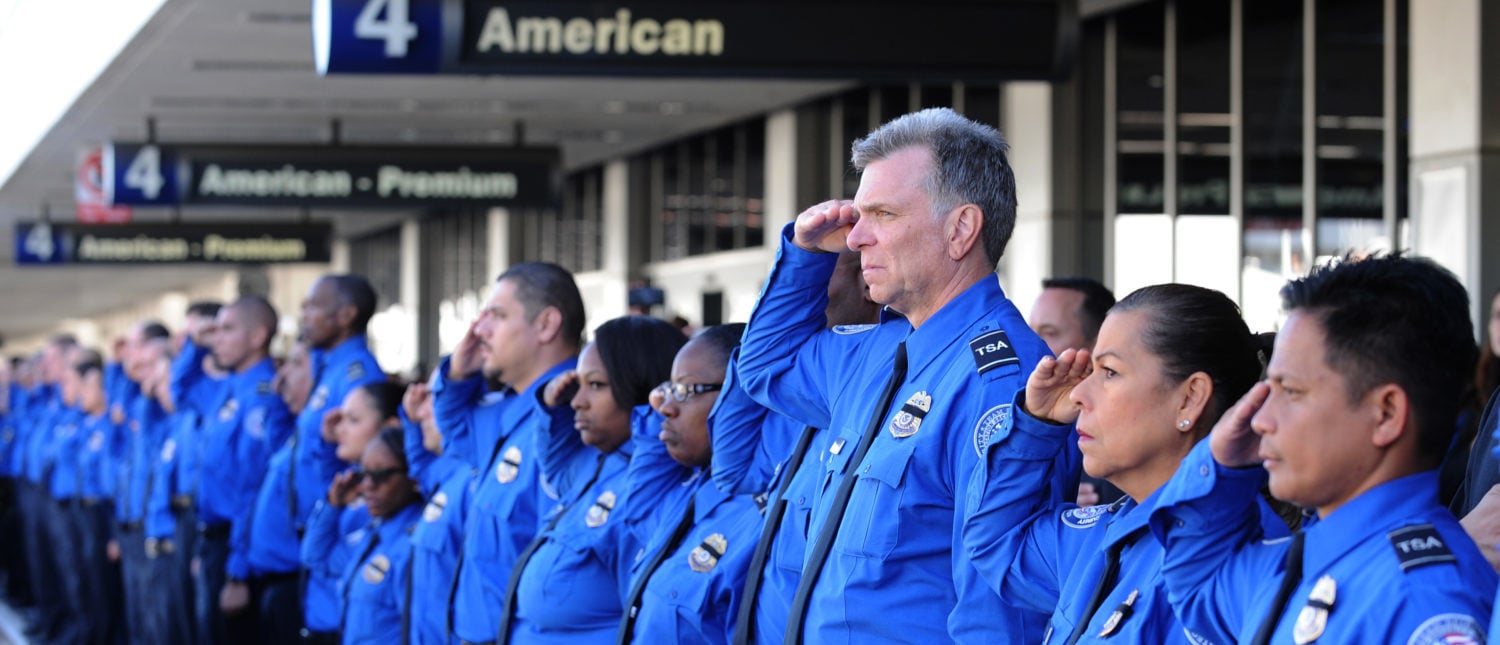 LOS ANGELES, CA - NOVEMBER 6: A long line of TSA personnel salute the U.S. Honor Flag procession as it leaves Los Angeles International Airport in memory of TSA agent Gerardo Hernandez on November 6, 2013 in Los Angeles, California. The Honor Flag will be used at Hernandez's upcoming funeral services. (Photo by Brad Graverson-Pool/Getty Images)