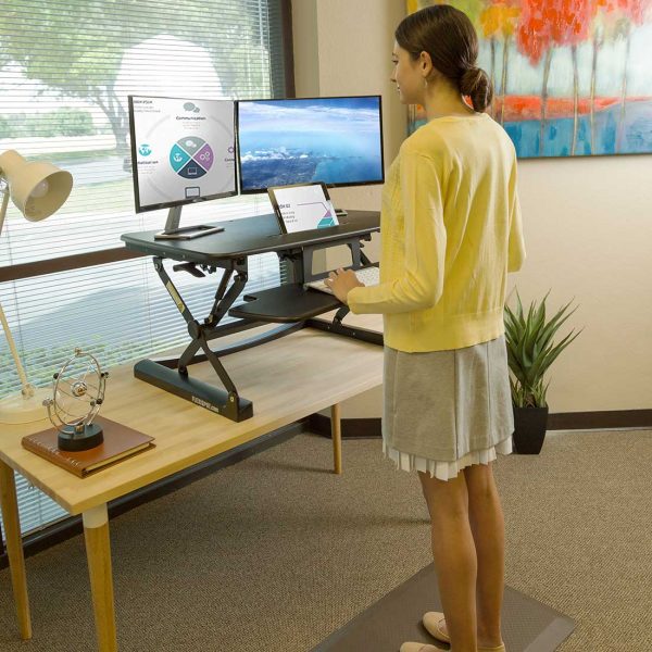 This Standing Desk Riser Goes Up And Down But Your Productivity