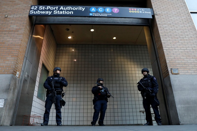 Police officers stand guard outside the closed New York Port Authority Subway entrance following an reported explosion, in New York City, U.S. December 11, 2017. REUTERS/Brendan McDermid