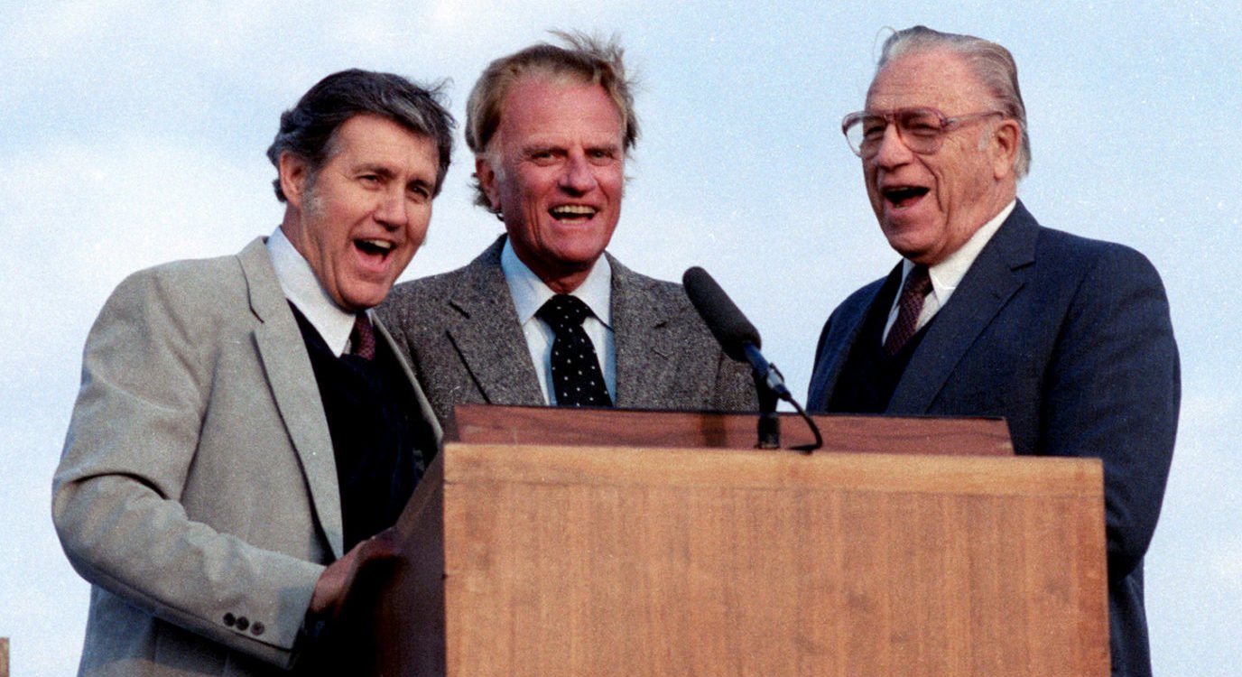 FILE PHOTO: L-R; Cliff Barrows, Rev. Billy Graham and George Beverly Shea sing 