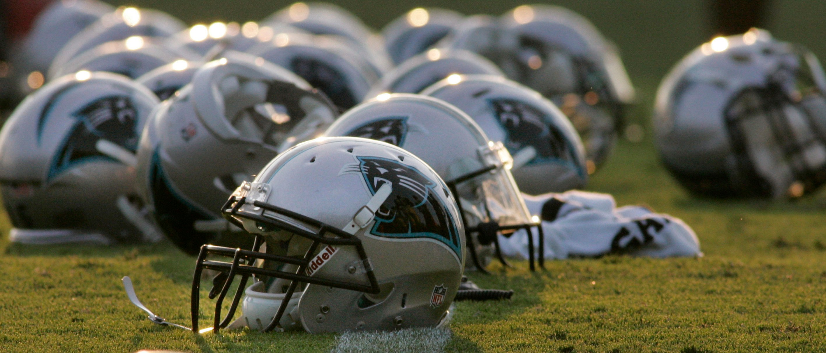 Carolina Panthers helmets are pictured on the field as players work out on their first day in pads at the NFL training camp at Wofford College in Spartanburg, South Carolina August 1, 2011.  REUTERS/Mary Ann Chastain