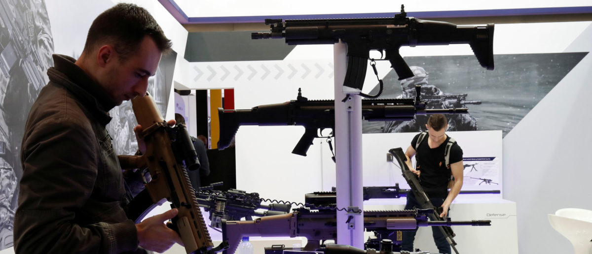Gun enthusiasts look over FN Herstal rifles that are displayed at the 20th Paris Milipol, the worldwide exhibition dedicated to homeland security, in Villepinte, near Paris, France, November 21, 2017. REUTERS/Benoit Tessier 