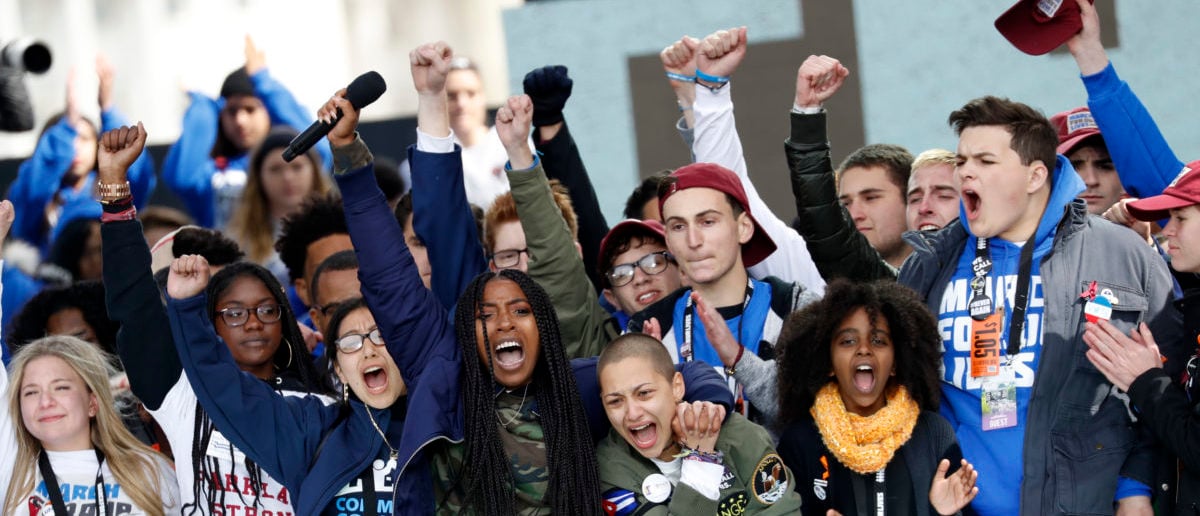 Shooting survivors Tyra Hemans (center, L) and Emma Gonzalez (3rd from R), from Marjory Stoneman Douglas High School in Parkland, Florida, lead the cheers along with 11-year-old Naomi Wadler of Alexandria, Virginia (2nd R) at the conclusion of the "March for Our Lives" event demanding gun control after recent school shootings at a rally in Washington, U.S., March 24, 2018. REUTERS/Aaron P. Bernstein 