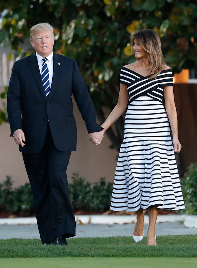 U.S. President Donald Trump and first lady Melania Trump hold hands as walk with Japan's Prime Minister Shinzo Abe and Abe's wife Akie (not pictured) as they arrive for a dinner at Trump's Mar-a-Lago estate in Palm Beach, Florida, U.S., April 17, 2018. REUTERS/Kevin Lamarque - HP1EE4H1T59QL