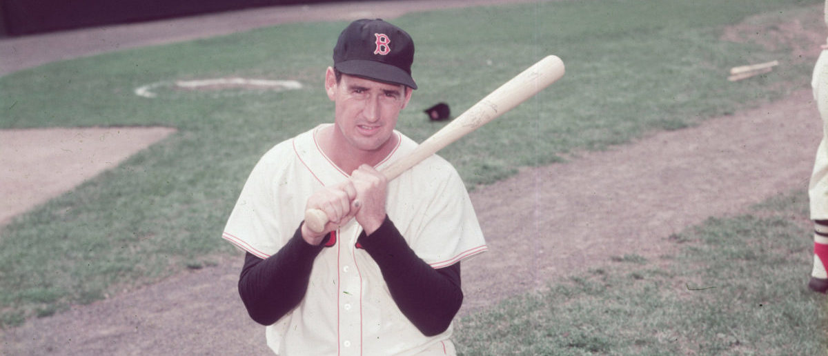 BOSTON, MA - CIRCA 1945:  (UNDATED FILE PHOTO)  Baseball legend Ted Williams (1918 - 2002) of the Boston Red Sox holds a baseball bat as he kneels on a baseball field circa 1955. Williams, 83-years-old, was pronounced dead July 5, 2002 at Citrus County Memorial Hospital in Florida. Williams died of an apparent heart attack.  (Photo by Getty Images)