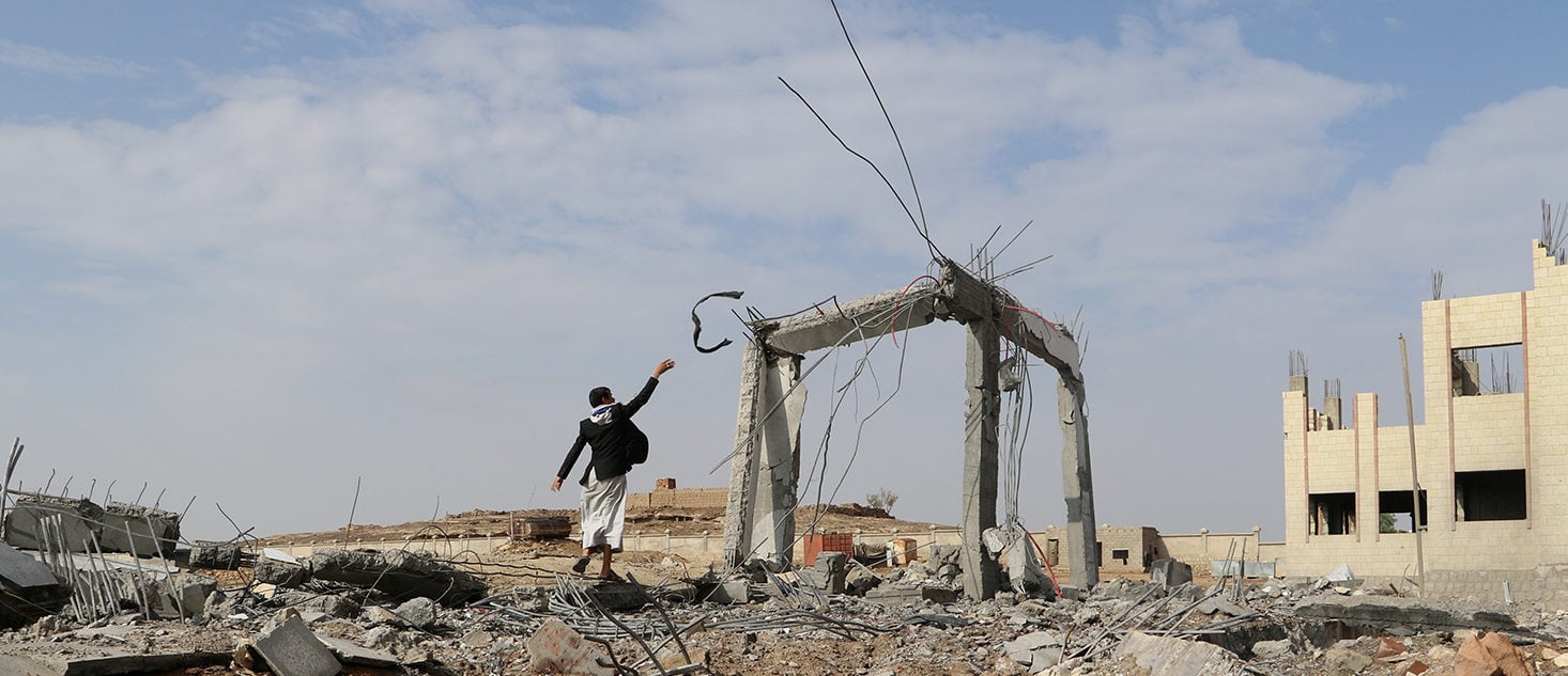 A man is seen at the site of an airstrike that destroyed the Community College in Saada, Yemen April 12, 2018. REUTERS/Naif Rahma 