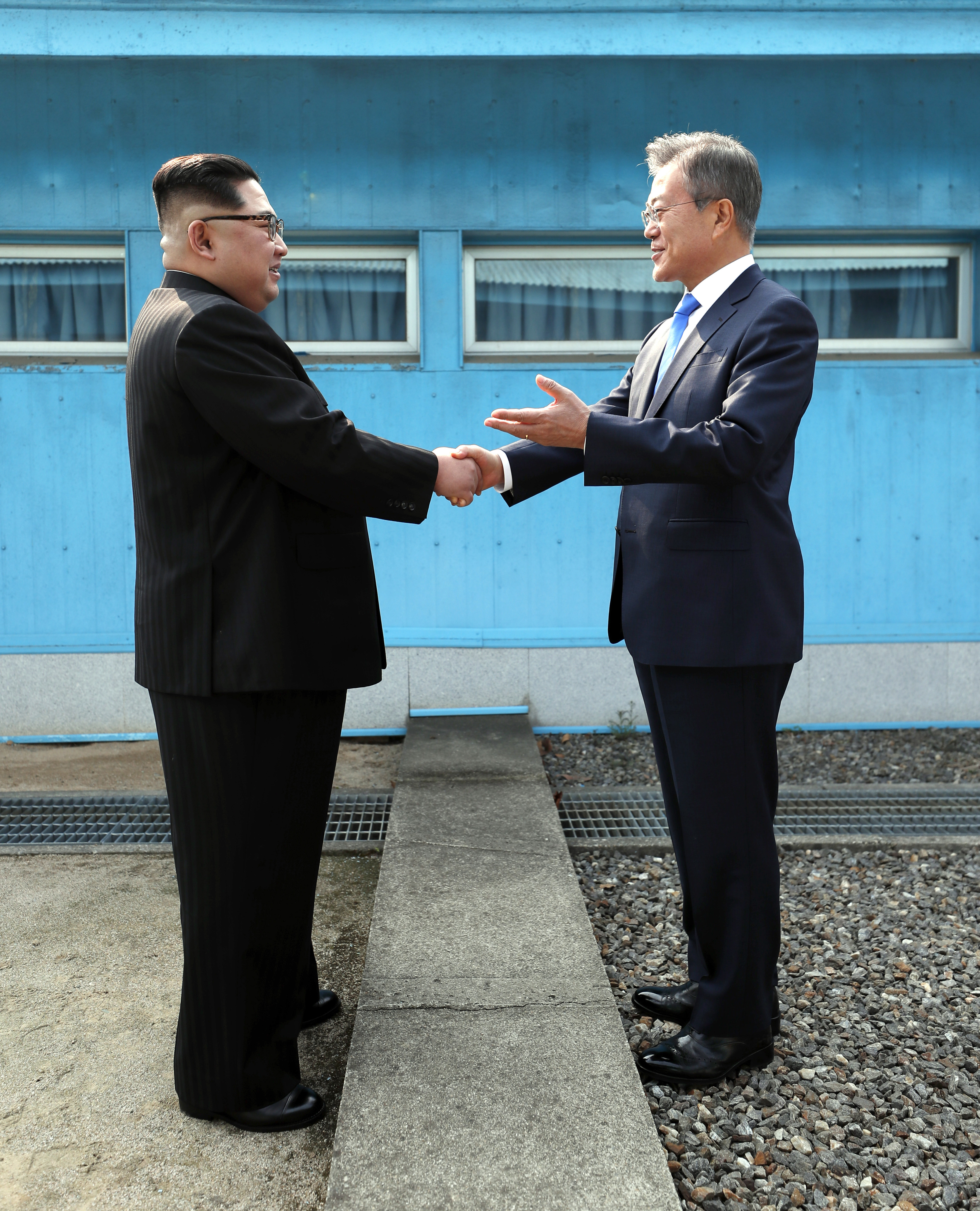 PANMUNJOM, SOUTH KOREA - APRIL 27: North Korean Leader Kim Jong Un (L) and South Korean President Moon Jae-in (R) shake hands over the military demarcation line upon meeting for the Inter-Korean Summit on April 27, 2018 in Panmunjom, South Korea. Kim and Moon meet at the border today for the third-ever inter-Korean summit talks after the 1945 division of the peninsula, and first since 2007 between then President Roh Moo-hyun of South Korea and Leader Kim Jong-il of North Korea. (Photo by Pool/Getty Images)