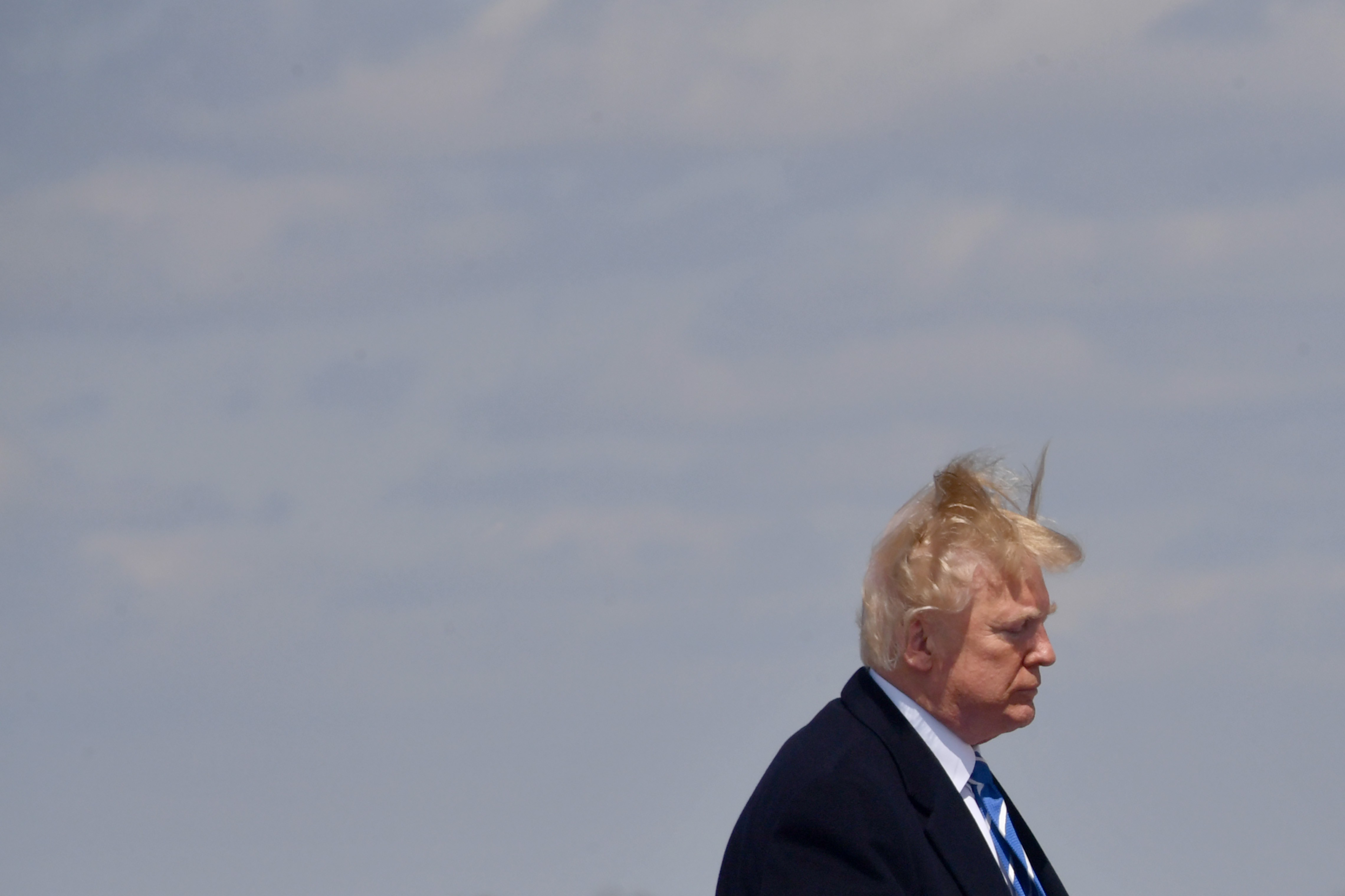 US President Donald Trump boards Air Force One on a windy day at Andrews Air Force base on April 5, 2018 near Washington, DC. Trump is heading to White Sulphur Springs, West Virginia for a round table discussion on tax reform. (NICHOLAS KAMM/AFP/Getty Images)