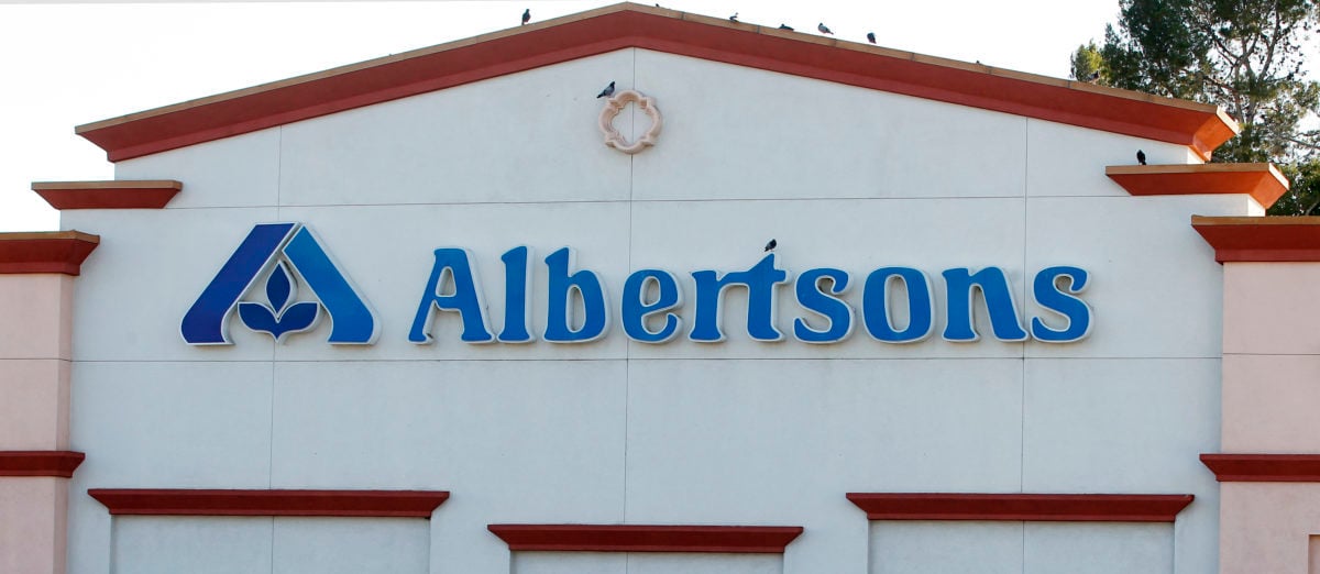 Birds perch upon signage for an Albertsons grocery store in Burbank, California July 17, 2012. Albertsons is owned by Supervalu, the third-largest U.S. grocery chain with other brands such as Jewel-Osco and Save-A-Lot. C&S Wholesale Grocers would be interested in buying the distribution business of grocer Supervalu Inc, which last week said it was exploring a sale of all or part of the company, the Wall Street Journal reported on Monday citing people familiar with the matter. REUTERS/Fred Prouser (UNITED STATES) | Grocery Store Harassed Hispanic Workers
