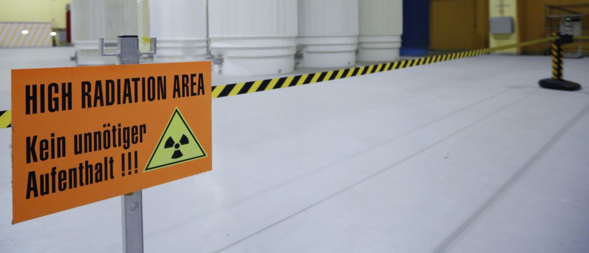 A sign that reads 'High Radiation Area - Avoid unnecessary stay!!!' is pictured in front of Castor nuclear waste containers (Cask for Storage and Transport of Radioactive material) at the ZWILAG interim storage facility for radioactive waste in Wuerenlingen October 30, 2014. Picture taken October 30, 2014. REUTERS/Ruben Sprich