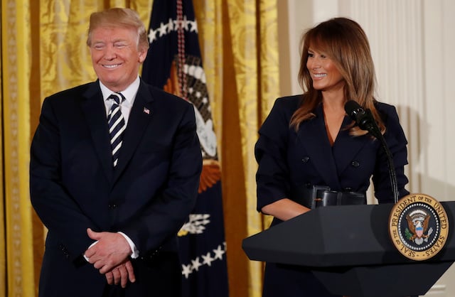 U.S. President Donald Trump and first lady Melania Trump participate in a celebration of military mothers and spouses at the White House in Washington, U.S., May 9, 2018. REUTERS/Leah Millis - RC19050D6760