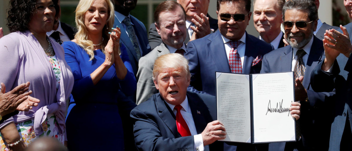 U.S. President Donald Trump signs an "Establishment of a White House Faith and Opportunity Initiative" proclamation after the National Day of Prayer ceremony at the White House in Washington, U.S., May 3, 2018. REUTERS/Leah Millis 