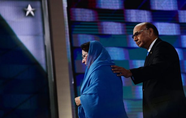 Khizr Khan (R), accompanied by his wife Ghazala Khan (L), walks off stage after speaking about their son US Army Captain Humayun Khan who was killed by a suicide bomber in Iraq 12 years ago, on the final night of the Democratic National Convention at the Wells Fargo Center, July 28, 2016 in Philadelphia, Pennsylvania. / AFP / Robyn Beck (Photo credit should read ROBYN BECK/AFP/Getty Images)