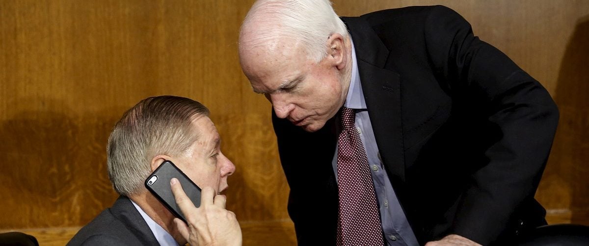 Senator John McCain (R-AZ) (R), the chair of the Senate Armed Services Committee, talks to Senator Lindsey Graham (R-SC) (L) before the committee heard testimony from U.S. Secretary of Defense Ash Carter (not pictured) in Washington December 9, 2015. REUTERS/Gary Cameron.