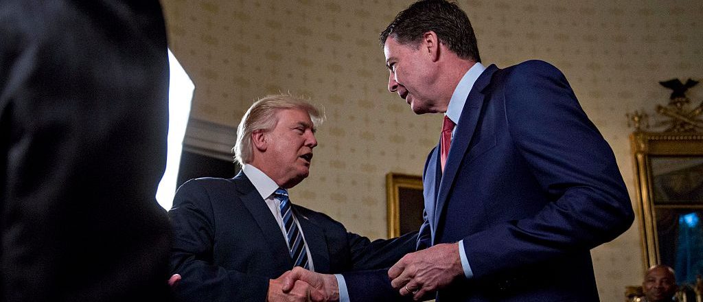 President Donald Trump shakes hands with James Comey, director of the Federal Bureau of Investigation, in the Blue Room of the White House on January 22, 2017 in Washington, DC. (Andrew Harrer-Pool/Getty Images)