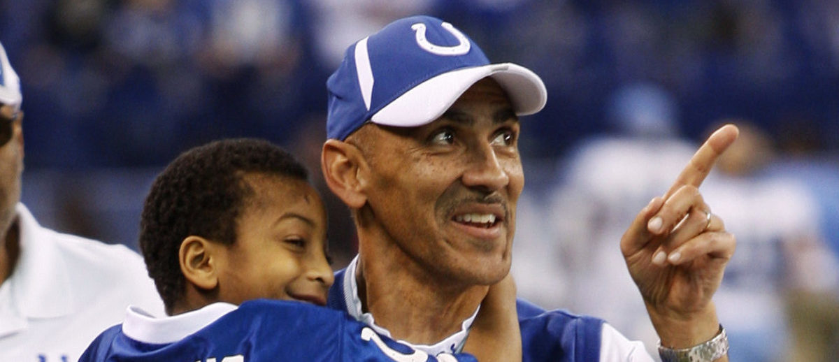 Indianapolis Colts head coach Tony Dungy carries his son Jordan from the field after beating the Tennessee Titans in their NFL game in Indianapolis December 28, 2008. REUTERS/Brent Smith