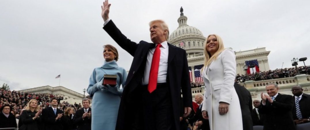 U.S. President Donald Trump acknowledges the audience after taking the oath of office as his wife Melania (L) and daughter Tiffany watch during inauguration ceremonies swearing in Trump as the 45th president of the United States on the West Front of the U.S. Capitol in Washington, DC, U.S., January 20, 2017. Jim Bourg: "This photo was shot with one of two remote cameras. The cameras were monitored and triggered remotely and the pictures were transmitted to clients worldwide within minutes of being taken." REUTERS/Jim Bourg/File Photo 