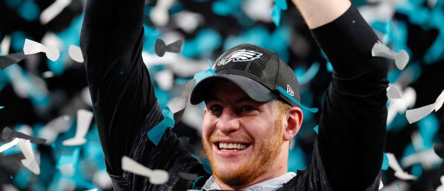 MINNEAPOLIS, MN - FEBRUARY 04:  Carson Wentz #11 of the Philadelphia Eagles celebrates with the Vince Lombardi Trophy after his teams 41-33 victory over the New England Patriots in Super Bowl LII at U.S. Bank Stadium on February 4, 2018 in Minneapolis, Minnesota. The Philadelphia Eagles defeated the New England Patriots 41-33.  (Photo by Kevin C. Cox/Getty Images)