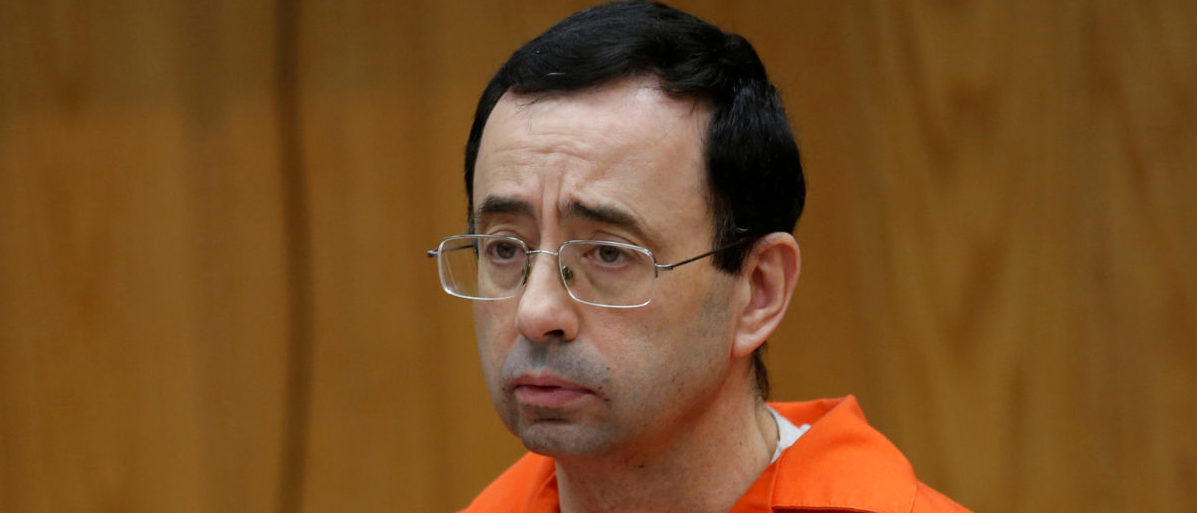 FILE PHOTO: Larry Nassar, a former team USA Gymnastics doctor who pleaded guilty in November 2017 to sexual assault, listens to victims impact statements during his sentencing in the Eaton County Circuit Court in Charlotte, Michigan, U.S., January 31, 2018.   REUTERS/Rebecca Cook/File Photo