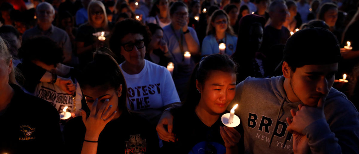People attend a candlelight vigil for victims of yesterday's shooting at nearby Marjory Stoneman Douglas High School, in Parkland, Florida, U.S. February 15, 2018. REUTERS/Carlos Garcia Rawlins 