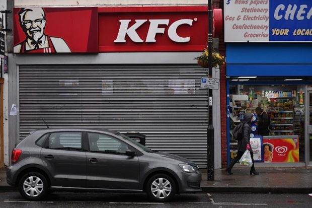 Pedestrians pass outside a closed KFC fast food store in south London on February 19, 2018. US fast food chain KFC said on February 19 it had been forced to close many restaurants in Britain because of a new supplier failing to deliver chicken in time, generating some tongue-in-cheek outrage on Twitter. / AFP PHOTO / BEN STANSALL (Photo credit should read BEN STANSALL/AFP/Getty Images)