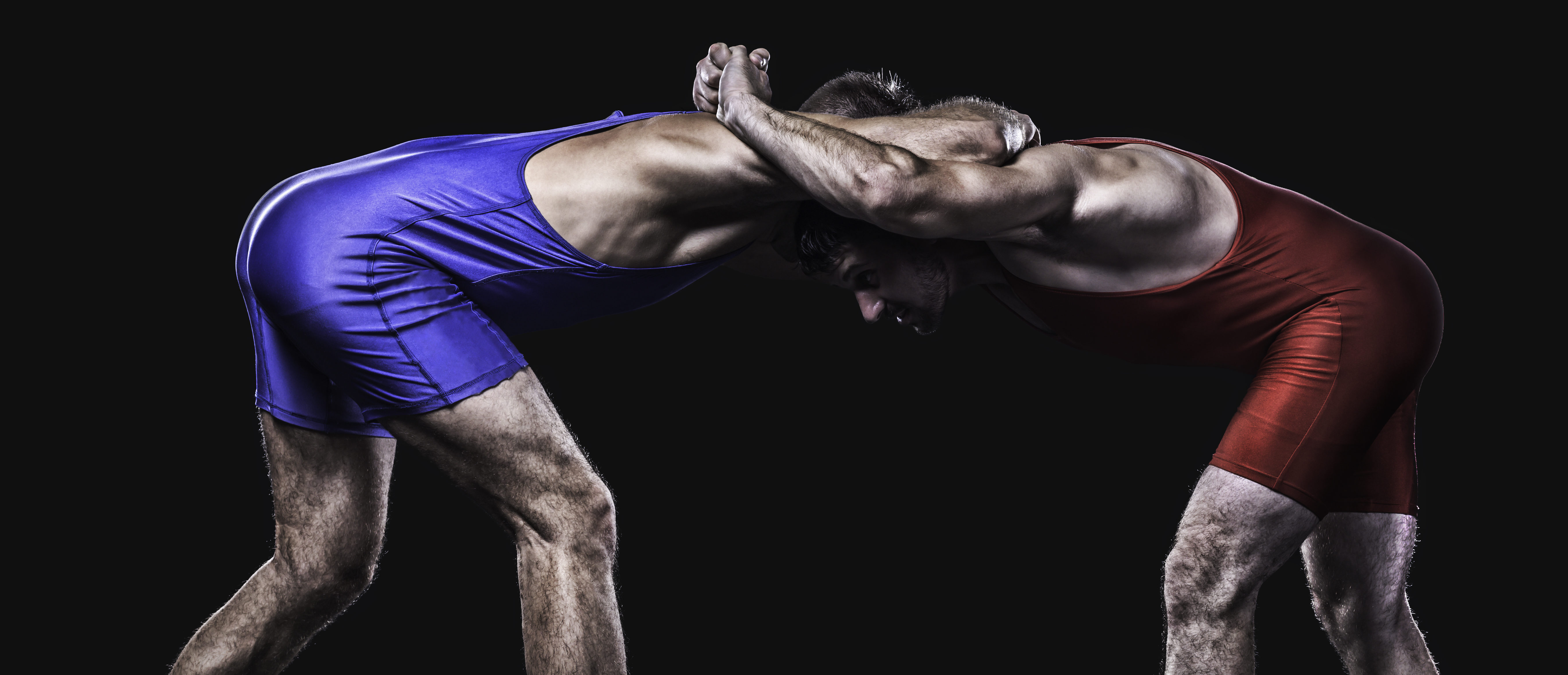 Two wrestlers in blue and red. (Shutterstock/Roka pics)