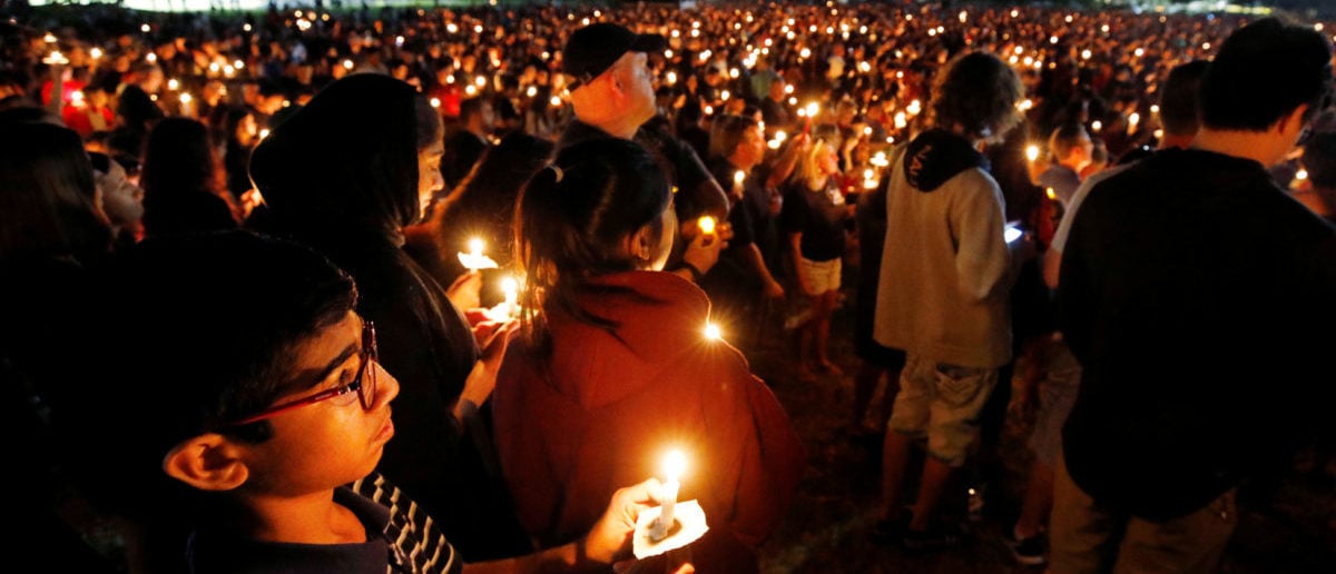 People attend a candlelight vigil the day after a shooting at Marjory Stoneman Douglas High School in Parkland, Florida, U.S. February 15, 2018.  REUTERS/Jonathan Drake 