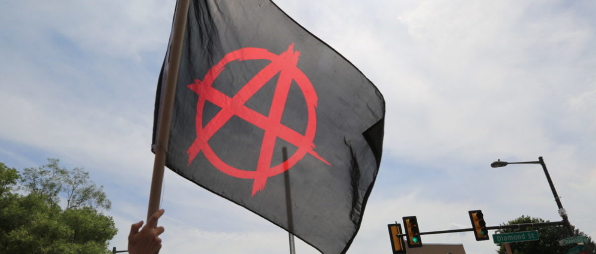 July 26th, 2016 Philadelphia, PA: Democratic National Convention - An Anarchist flag waves over a crowd of demonstrators. (Shutterstock/Belltreephotography) | Anarcho-Students Deal With Snitches
